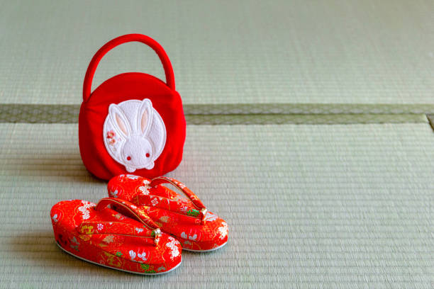 Traditional Japanese footwear and bag on tatami mat.