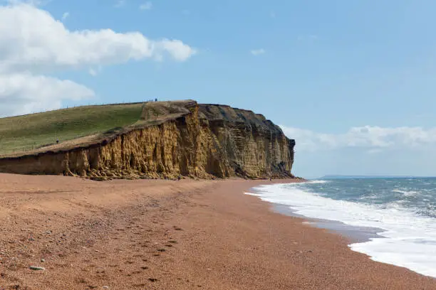 Freshwater Bay beach Dorset with waves and sandstone cliffs Jurassic coast