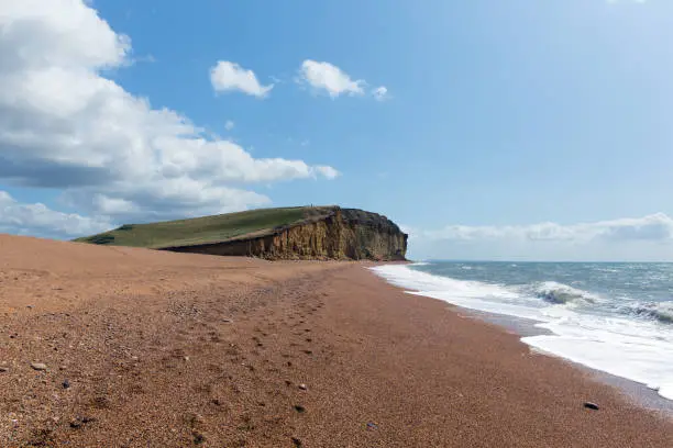 Freshwater Bay beach Dorset with waves and sandstone cliffs