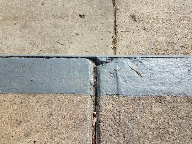 istock grey cement sidewalk with lines and painted curb 1173589759
