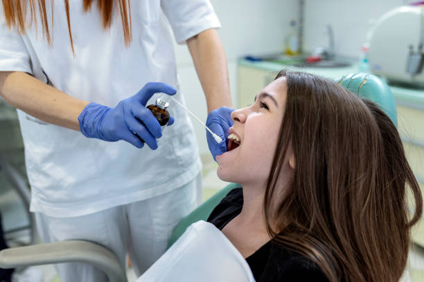 istock Dentist is using Dental Spray on her Young Patient 1173591670