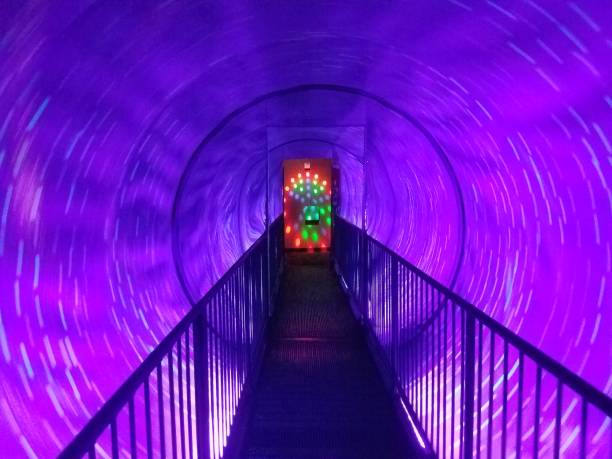 istock spinning purple light tunnel with walkway 1173592927