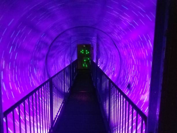 istock spinning purple light tunnel with walkway 1173593005
