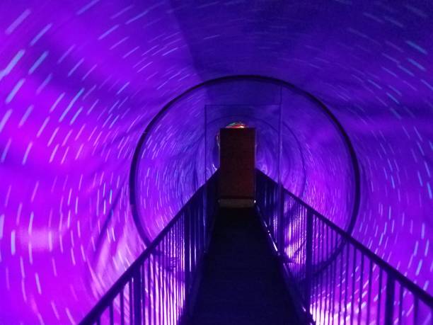 istock spinning purple light tunnel with walkway 1173593063
