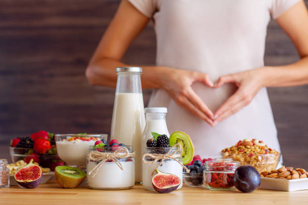 Healthy fitness food for breakfast Female make shape of heart with her hands. Light summer breakfast with organic yogurts, fruits, berries and nuts. Nutrition that promotes good digestion and functioning of gastrointestinal tract. bifidobacterium stock pictures, royalty-free photos & images