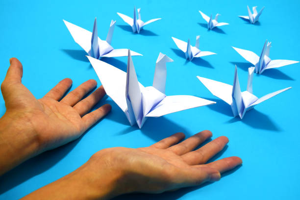 istock origami birds are flying on blue sky background. freedom concept. 1173594621