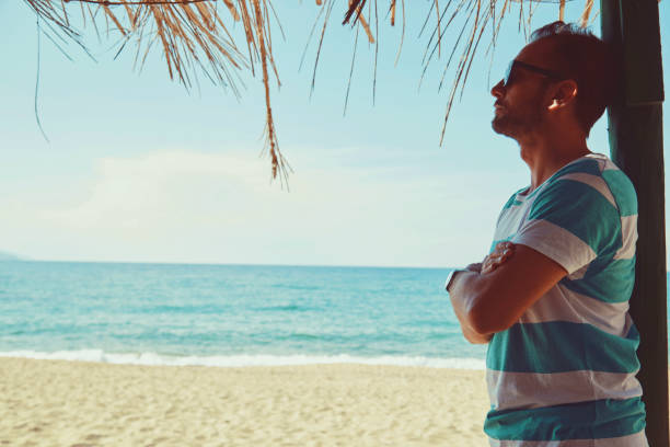 istock Attractive man enjoying on the tropical beach. Summer concept. 1173596192