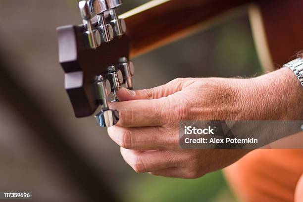Guitar Player Tune The Musical Instrument Stock Photo - Download Image Now - Piano Tuner, Guitar, Adult