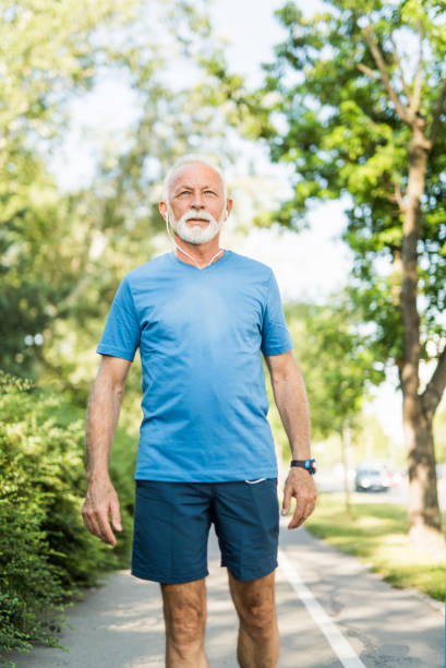 istock Sporty senior man walking in the park. 1173599042