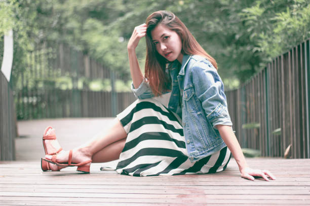 istock woman sitting on a park bridge 1173599478
