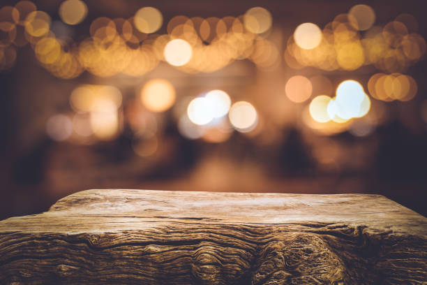 istock Wood texture table top (counter bar) with blur light gold bokeh in cafe,restaurant background 1173599531