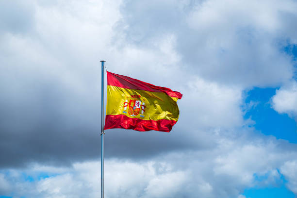 istock National Spanish flag in blue sky with clouds Spain 1173602919