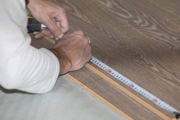 istock worker puts a new laminate on the floor 1173602971