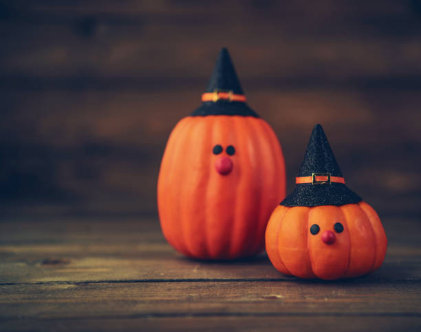 Halloween still life background with witch couple made from pumpkins
