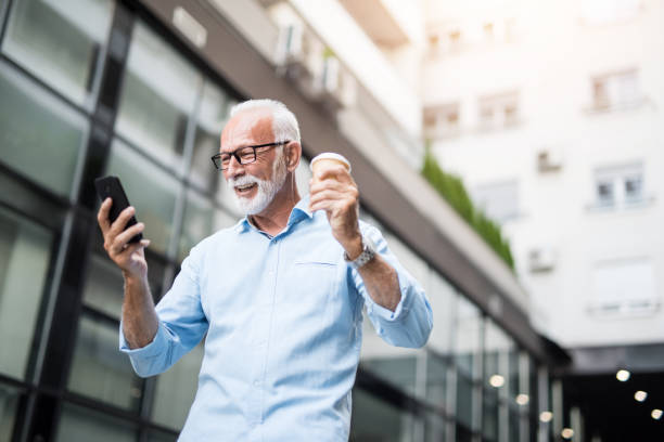 istock Happy excited senior man using phone on a coffee break. 1173604436