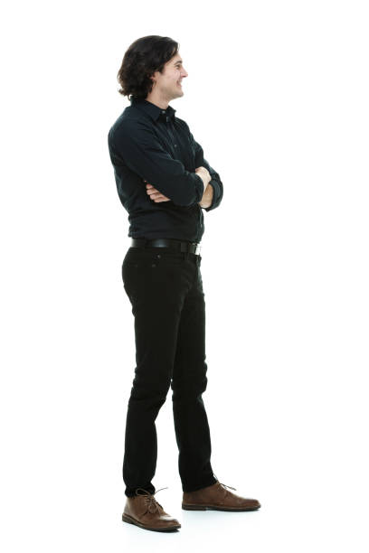 Full length / one man only / side view / profile view of 20-29 years old handsome people / long hair caucasian male standing in front of white background wearing button down shirt / shirt / jeans who is smiling / happy / cheerful / cool attitude longitud completa / solo un hombre / vista lateral / vista de perfil de 20-29 años de edad gente hermosa / pelo largo hombre caucásico de pie delante de fondo blanco usando botón hacia abajo camisa / camisa / jeans que sonríe / feliz / alegre / actitud