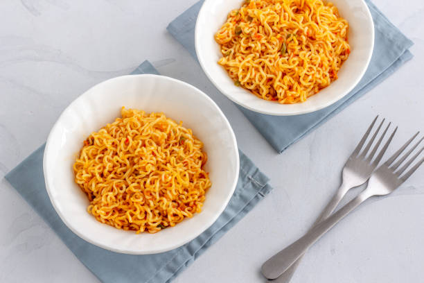 istock Two Bowls of Instant Noodles with Fork on White Background 1173607809