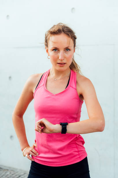 istock Sporty woman checking time on smart watch 1173608377