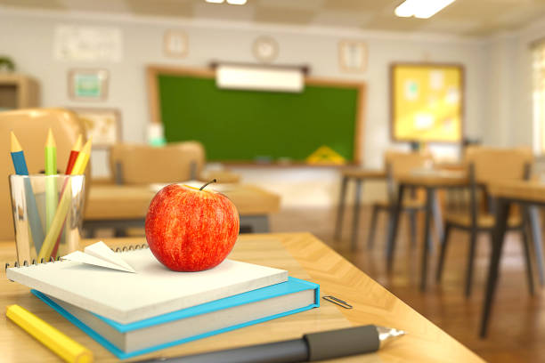 istock Cartoon style school elements - book, pen, pencils and red apple on desk in empty classroom. 3D rendering illustration. 1173608582