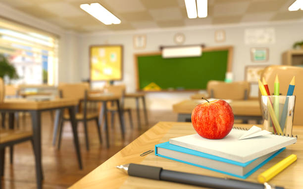 istock Cartoon style school elements - book, pen, pencils and red apple on desk in empty classroom. 3D rendering illustration. 1173608617