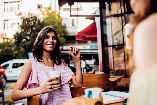 istock Middle Eastern girls having coffee and talking 1173613037