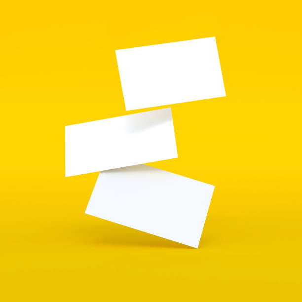 istock Falling blank white business cards on yellow background. 3D render illustration. Mockup design. 1173614257