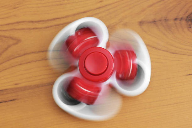 istock Two spinners on wooden background 1173615442