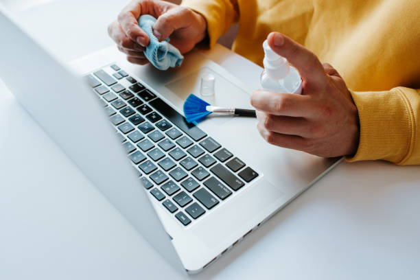 istock Laptop cleaning up. Service for cleaning notebook screen, keyboard, case. Cleaning accessories: brush, cloth, spray. Computer monitor, display care. Professional service, clean up. Man who wipe laptop 1173615811