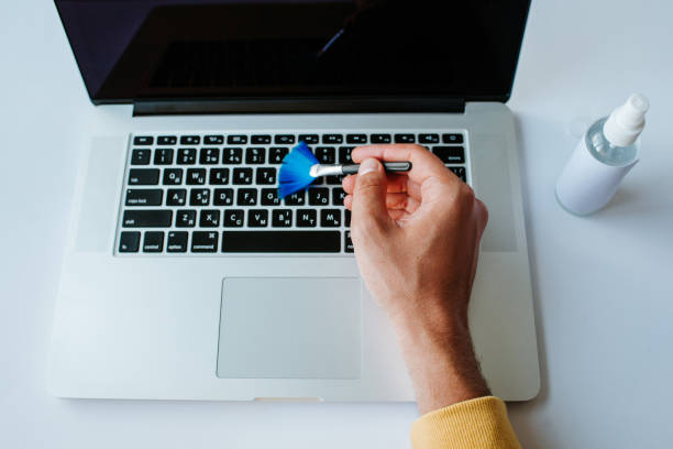 istock Laptop cleaning up. Service for cleaning notebook screen, keyboard, case. Cleaning accessories: brush, cloth, spray. Computer monitor, display care. Professional service, clean up. Man who wipe laptop 1173615839