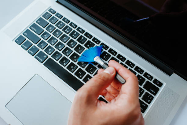 istock Laptop cleaning up. Service for cleaning notebook screen, keyboard, case. Cleaning accessories: brush, cloth, spray. Computer monitor, display care. Professional service, clean up. Man who wipe laptop 1173615861