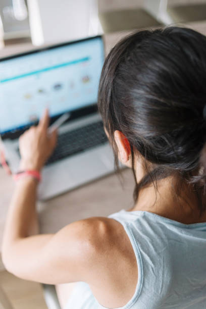 istock Woman with laptop working at home 1173616268