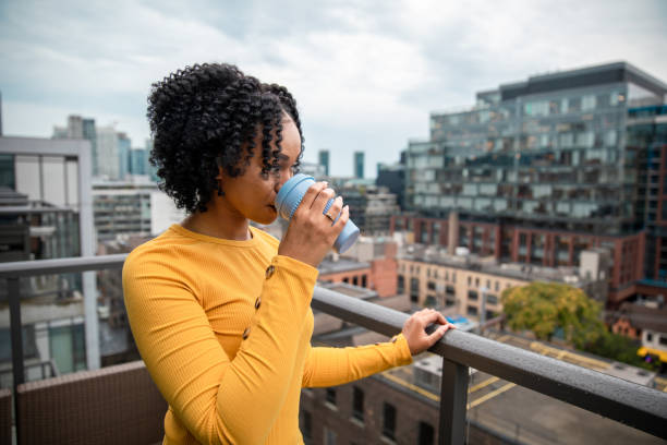 istock Woman Holding a Reusable Cup 1173616326
