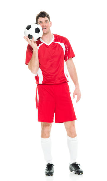 Full length / one man only of 30-39 years old handsome people caucasian male / mid adult men / mid adult soccer player standing in front of white background wearing soccer uniform who is smiling / happy / cheerful and holding soccer ball / ball / sport / soccer field longitud completa / un hombre sólo de 30-39 años de edad gente guapo hombres / hombres adultos medios / jugador de fútbol adulto medio de pie frente a fondo blanco usando uniforme de fútbol que es sonriente / feliz / alegre y sosteniendo la pelota de f