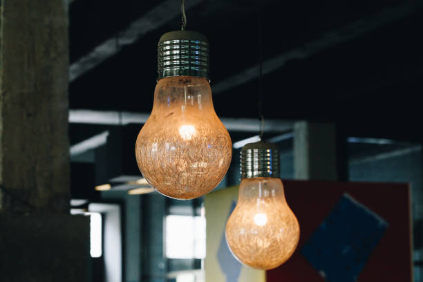istock Industrial pendant lamps against wall. Loft interior. Edison bulbs. Concept interior lighting 1173618115
