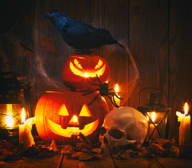 istock Halloween Jack-o-Lantern Pumpkins on rustic wooden background 1173619510