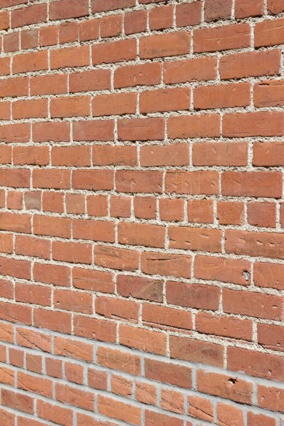 istock Scrappy old clay brick wall background with lots of deterioration 1173621826