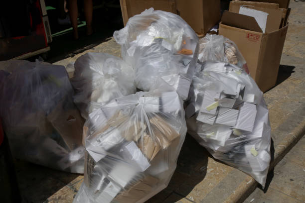 istock White plastic garbage bags and trash piled up on the street 1173622596