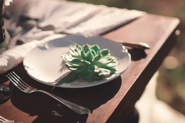 istock Vintage table setting with flower on a plate on a wooden table. 1173623118