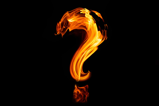 Fire question mark on black background, texture, close up