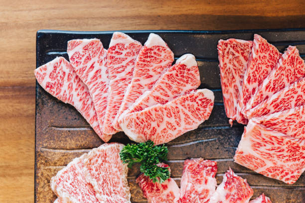 Close-up top view of Premium Rare Slices many parts of Wagyu A5 beef with high-marbled texture on stone plate served for Yakiniku (Grilled Meat). Close-up top view of Premium Rare Slices many parts of Wagyu A5 beef with high-marbled texture on stone plate served for Yakiniku (Grilled Meat). marbled meat stock pictures, royalty-free photos & images