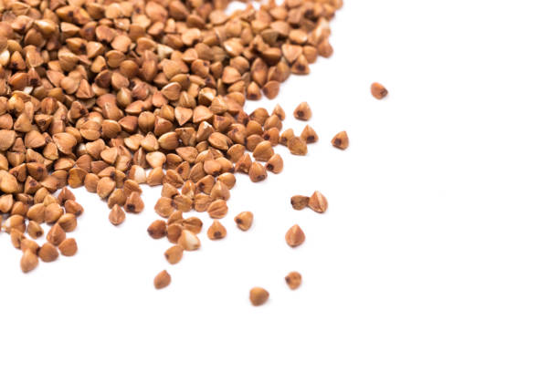 istock buckwheat grain isolated on white background close up with copy space for your text. Top view 1173627151