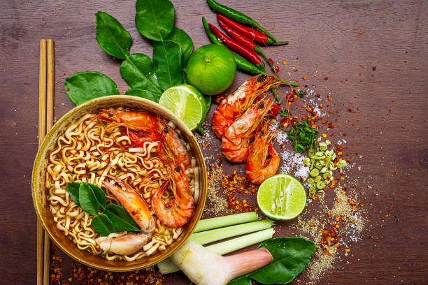 top view "tom yum kung" on wooden background, it's local in thai food, prawn soup is popular and famous food, i'ts delicious amazing taste hot and spicy, - sopa tom yum imagens e fotografias de stock