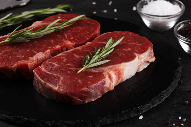 istock Steak raw. Barbecue Rib Eye Steak or rump steak on dark rustic table 1173627561