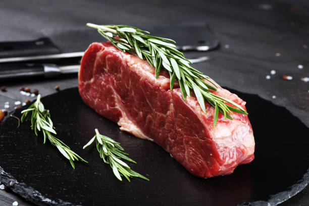 istock Steak raw. Barbecue Rib Eye Steak or rump steak on dark rustic table 1173627733