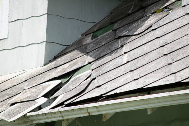 istock Damaged and old roofing shingles and gutter system on a house 1173628348