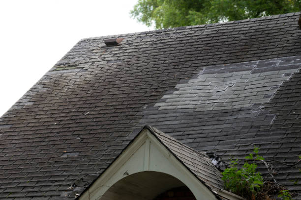 istock Damaged and old roofing shingles and gutter system on a house 1173628372