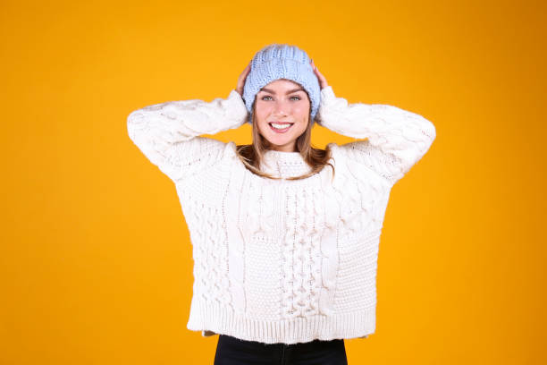 istock Gorgeous female with snow white smile posing over yellow background. 1173628392