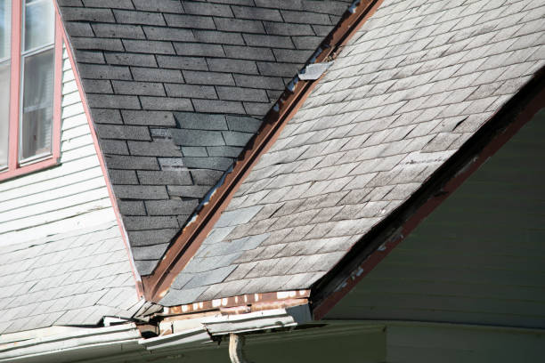 istock Damaged and old roofing shingles and gutter system on a house 1173628425