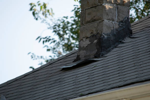 istock Damaged and old roofing shingles and gutter system on a house 1173628469
