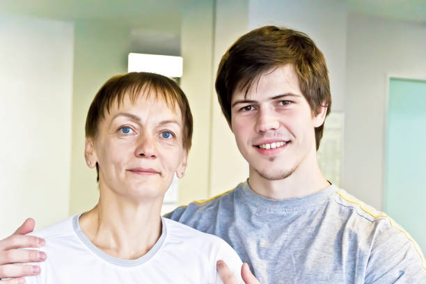 Smiling beautiful elderly woman and young man